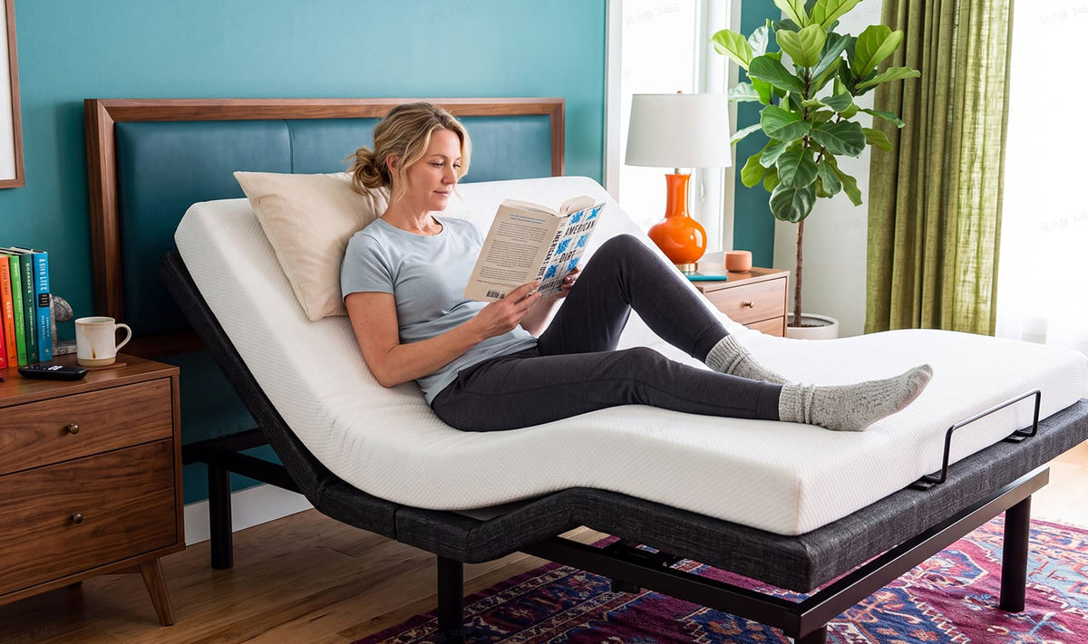 Woman reading in an adjustable bed with the head and foot sections raised in a modern bedroom