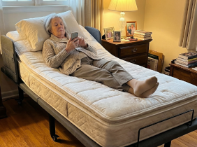 A woman resting in an adjustable bed